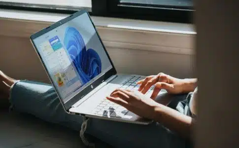 person using Windows 11 computer on lap